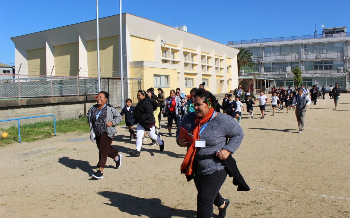 The UNITAR 2019 disaster risk reduction training participants run in a community tsunami evacuation drill in Wakayama Prefecture.