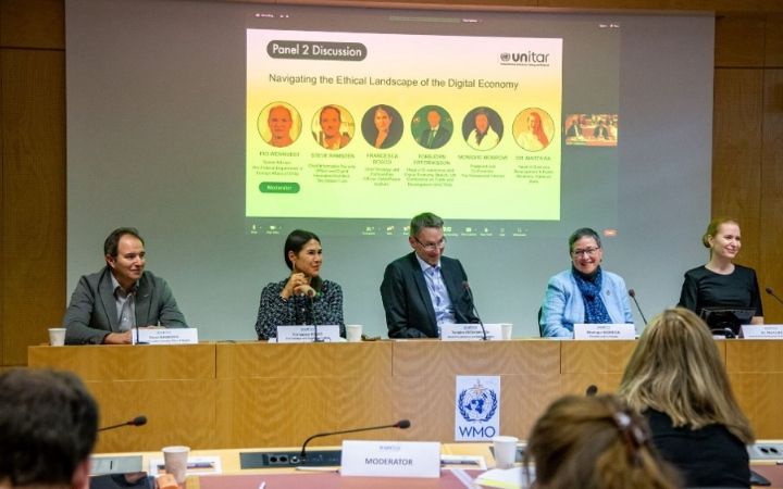 A panel discussion is taking place in a conference room.