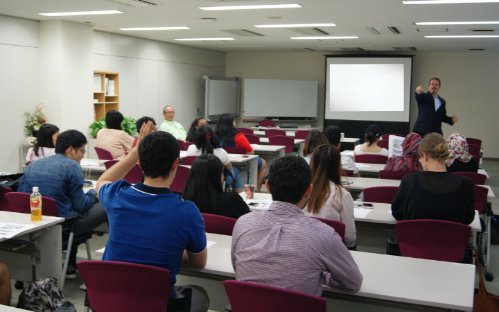 UNITAR staff pointing to a student who is raising his hand in class