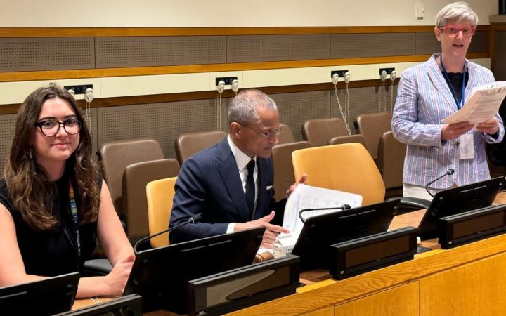 Mr. Burhan Gafoor sitting down speaking in front of the mic