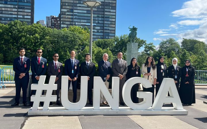 A group photo of the fellows infront of the UNGA sign