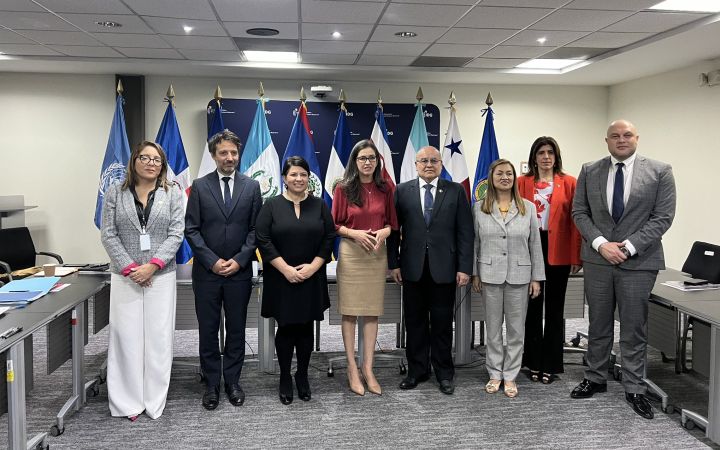 Speakers standing in front of the room for a group photo