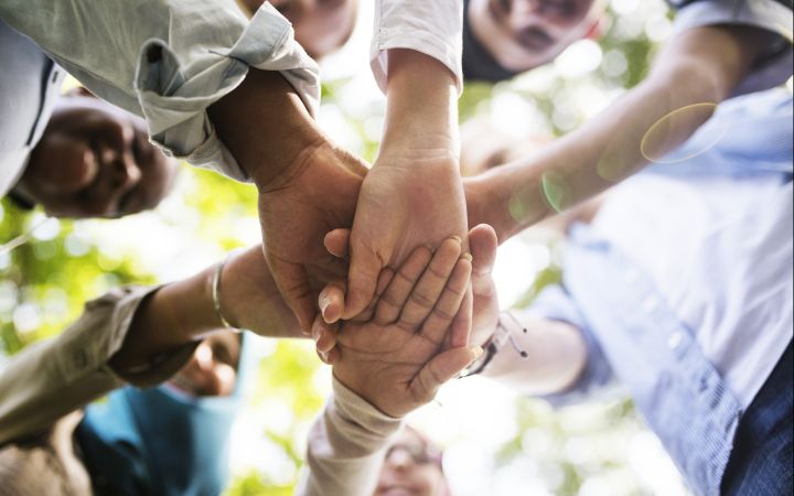 Group of diverse youth hands joined
