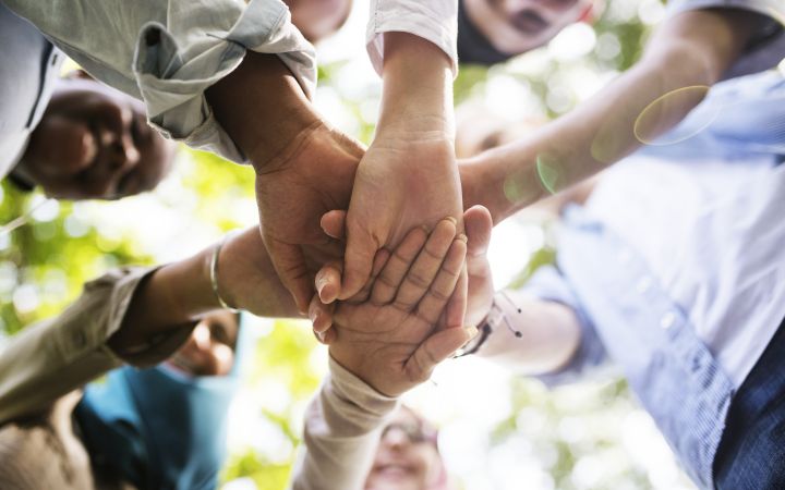 Group of diverse youth hands joined