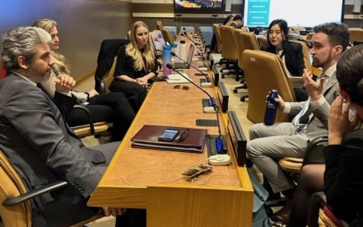 Participants sitting around a table and talking.