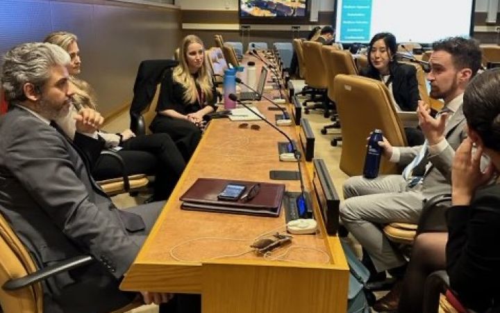 Participants sitting around a table, talking.