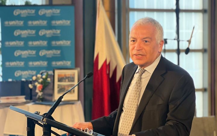 Amb. H.E. Marco Suazo standing in front of the mic