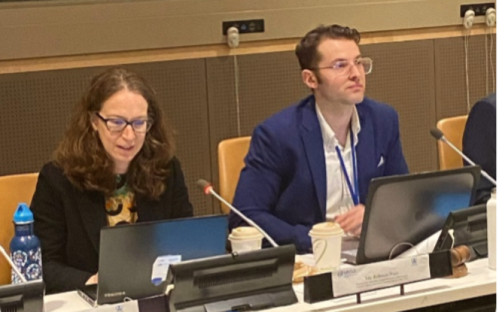 Two people sitting in front of microphones and screens