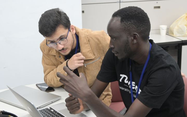 Kuena James explaining his project with his fellow participant.