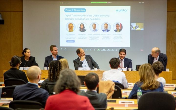 A panel discussion on digital transformation in the global economy taking place in a conference room