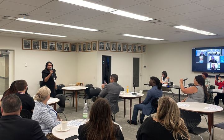 GDI Fellow Introduces herself in front of conference room