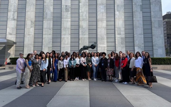 Fellows standing in front of the building for a group photo