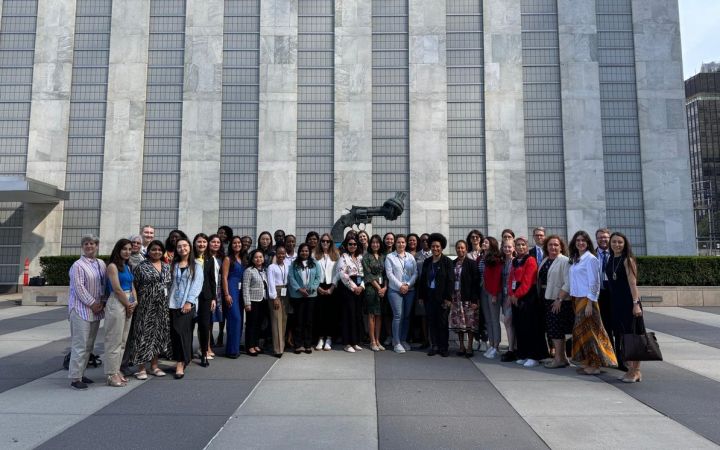 Fellows standing in front of the building for a group photo
