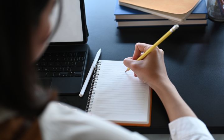 Woman writing on her notebook