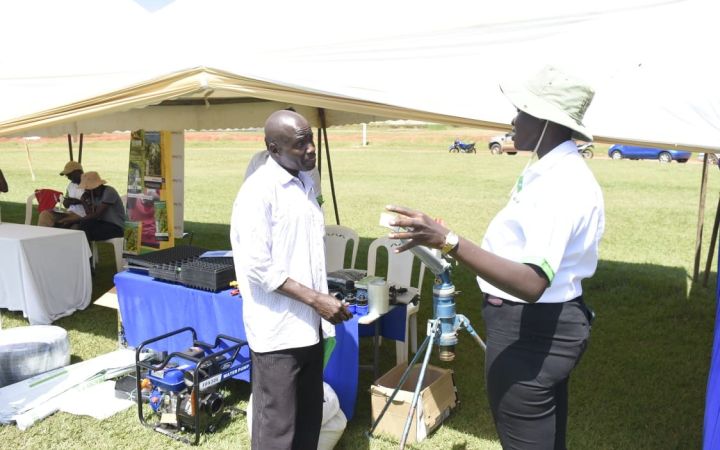 Cynthia Achieng discussing with a farmer at the site
