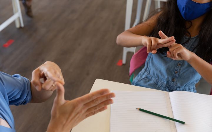 Student and teacher using sign language