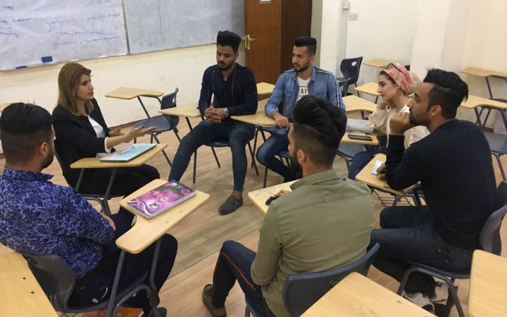 Raghad (second from left) at the university with a group of her students 