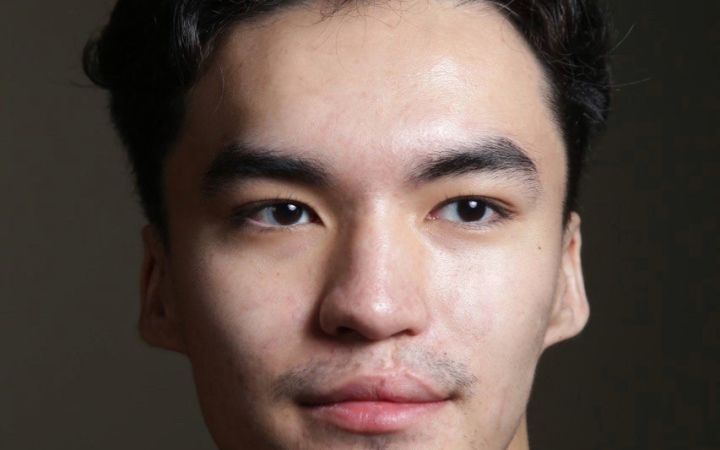 A profile photo of Yerdaulet Rakhmatulla in a green shirt