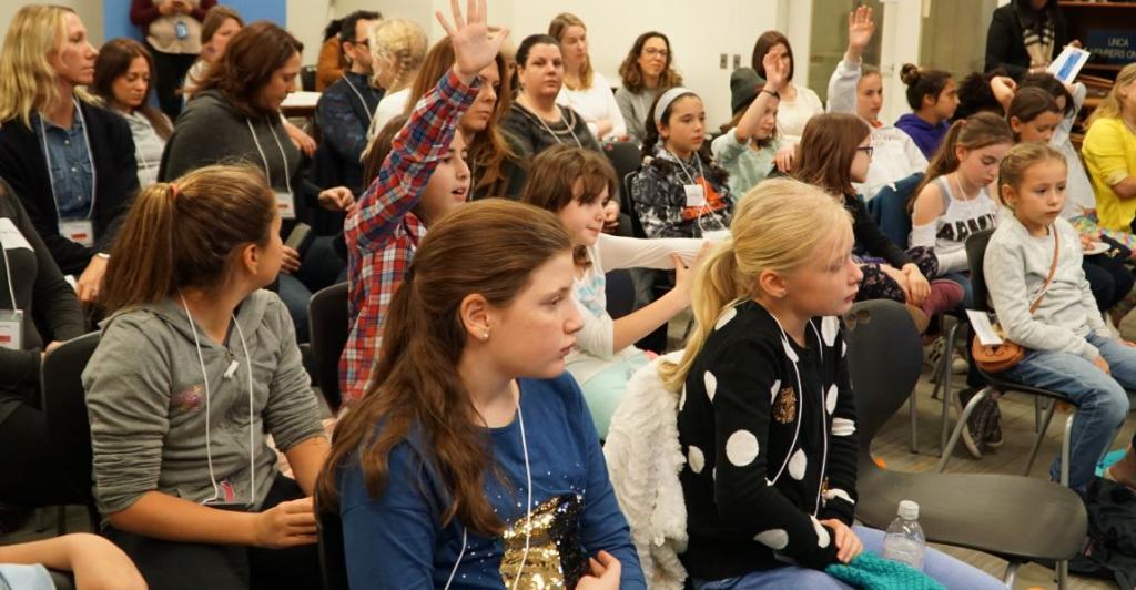 Girls asking panelists questions 